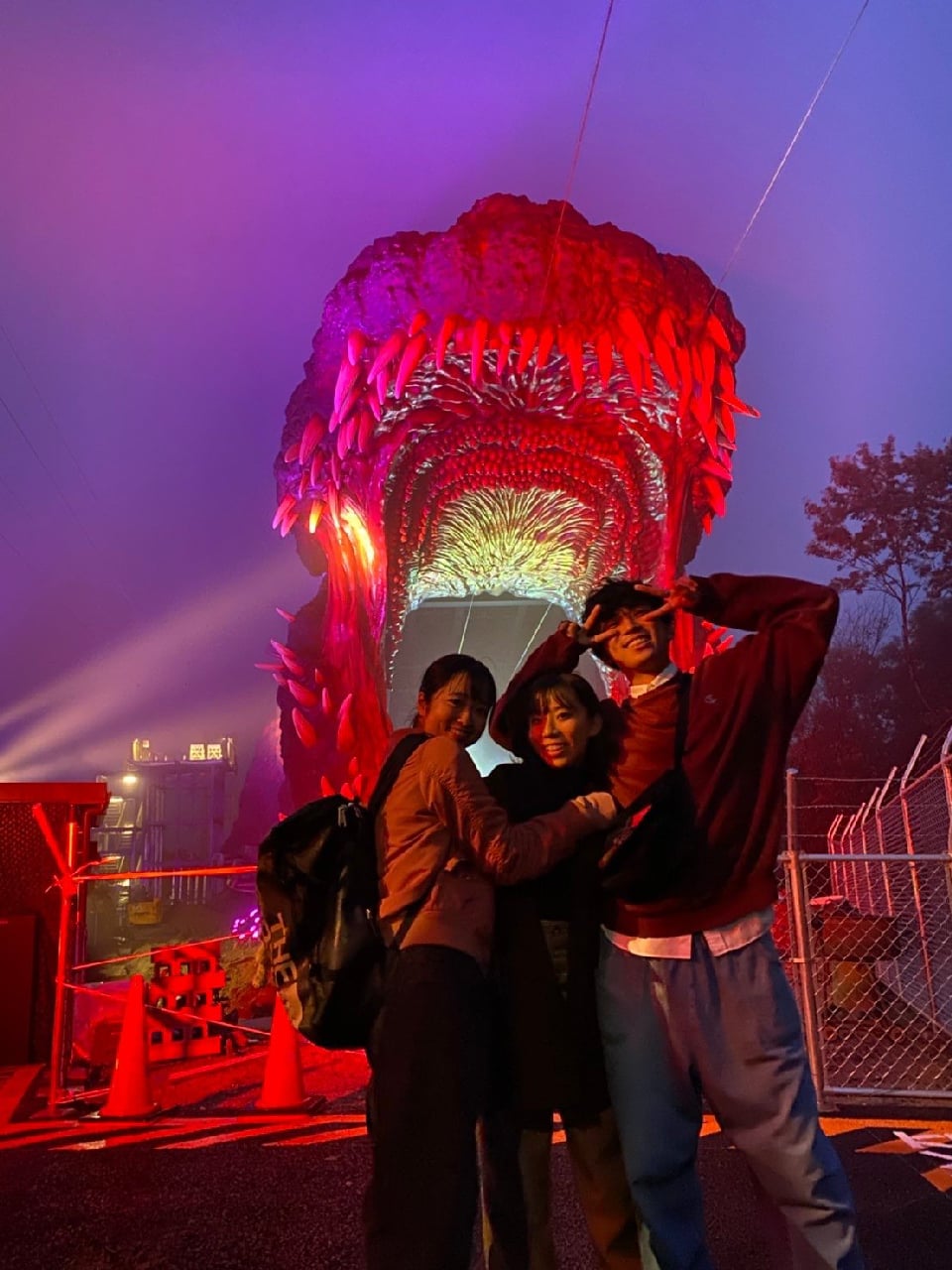 Godzilla is lit up at night, making for a spectacular sight!] The